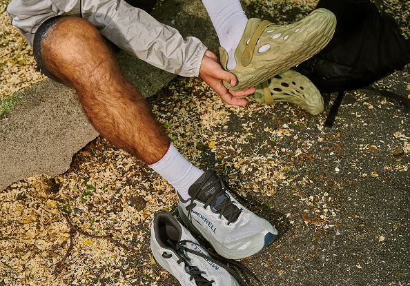 A men changin shoes from Merrell ProMorph to Merrell Hydro Mocs